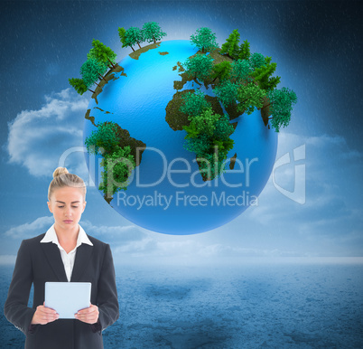 Composite image of businesswoman holding new tablet