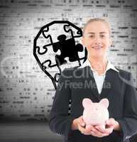 Composite image of businesswoman holding piggy bank