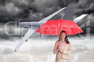 Composite image of attractive businesswoman holding red umbrella