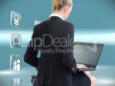 Composite image of businesswoman using laptop