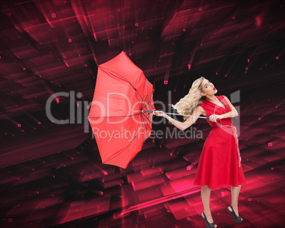 Composite image of elegant blonde holding umbrella