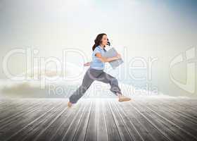 Composite image of cheerful classy businesswoman jumping while h