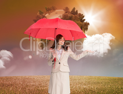 Composite image of attractive businesswoman holding red umbrella