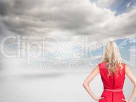 Composite image of elegant blonde standing hands on hips