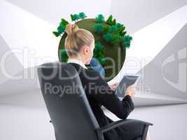 Composite image of businesswoman sitting on swivel chair with ta