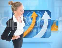 Composite image of businesswoman standing with hands on hips