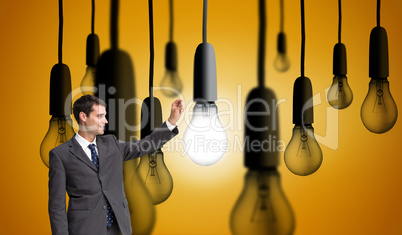 Composite image of smiling businessman holding something up in t