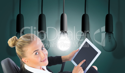 Composite image of businesswoman sitting on swivel chair with ta