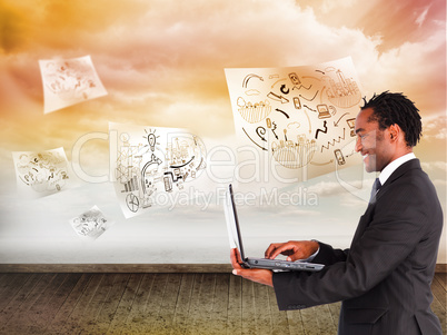 Composite image of businessman working on laptop