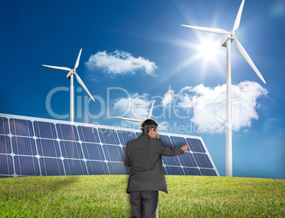 Composite image of businessman standing on ladder