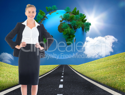 Composite image of businesswoman standing with hands on hips