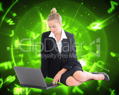 Composite image of businesswoman using laptop