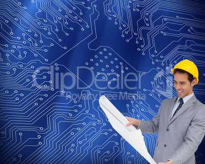Composite image of smiling architect with hard hat looking at pl