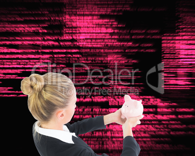 Composite image of businesswoman holding piggy bank