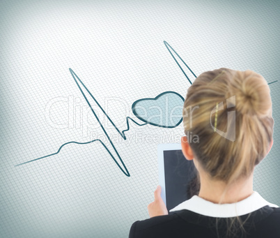 Composite image of businesswoman holding tablet