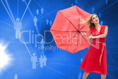 Composite image of elegant blonde holding umbrella