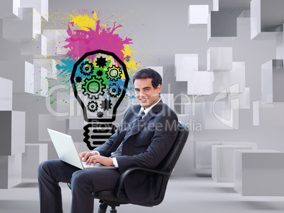 Composite image of young businessman sitting on an armchair work