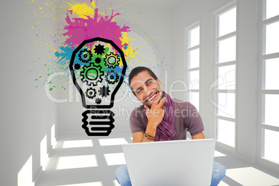 Composite image of thinking man sitting on floor using laptop an Composite image of thinking man sitting on floor using laptop an
