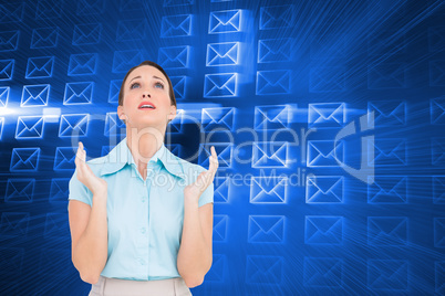 Composite image of concerned young businesswoman praying