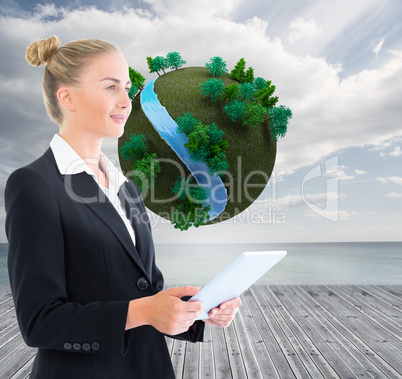 Composite image of businesswoman holding tablet