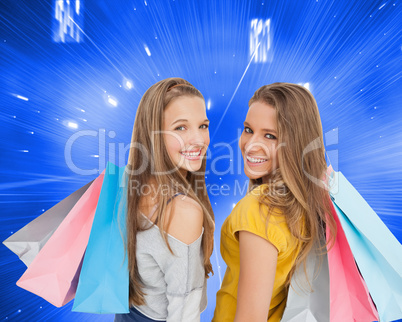 Composite image of two young women with shopping bags