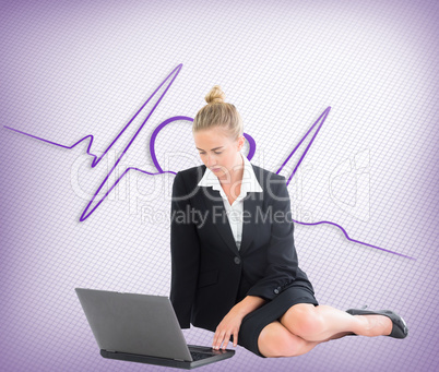 Composite image of businesswoman using laptop