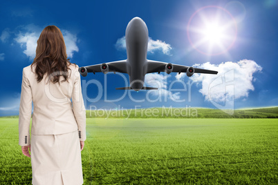 Composite image of classy businesswoman walking away from camera