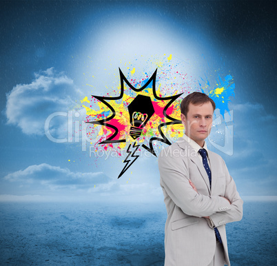 Composite image of serious businessman standing with his arms fo