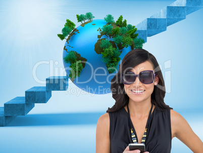 Composite image of happy brunette holding smartphone