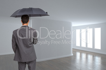 Composite image of rear view of classy businessman holding grey