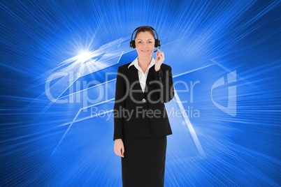 Composite image of good looking woman in suit using headphones a