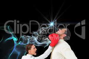 Composite image of businesswoman hitting a businessman with boxi