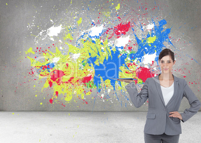 Composite image of smiling businesswoman holding tablet pc