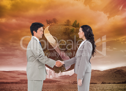 Composite image of side view of hand shaking trading partners