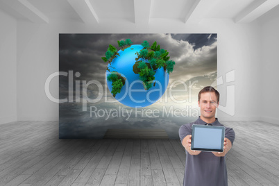 Composite image of young man showing screen of his tablet comput