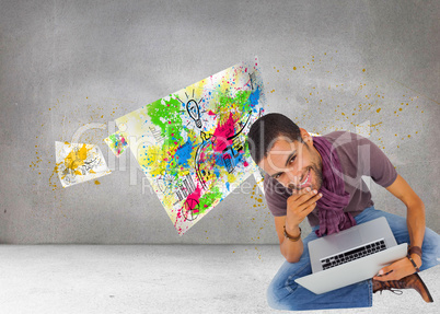 Composite image of thoughtful man sitting on floor using laptop