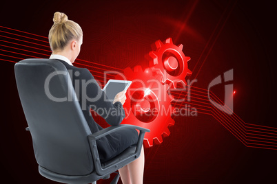 Composite image of businesswoman sitting on swivel chair with ta