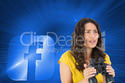 Composite image of serious casual young woman holding binoculars