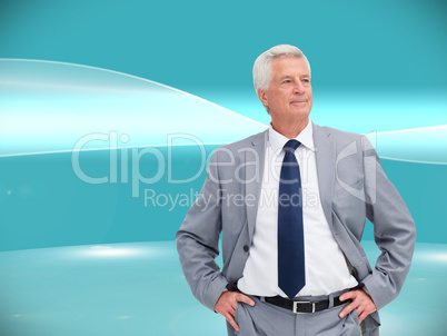 Composite image of man in a suit with his hands on his hips