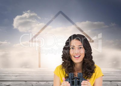 Composite image of smiling casual young woman holding binoculars