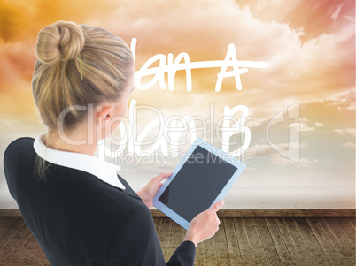 Composite image of businesswoman holding tablet Composite image of businesswoman holding tablet