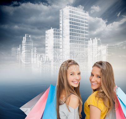 Composite image of two young women with shopping bags