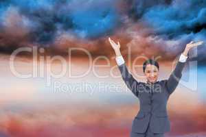 Composite image of cheering businesswoman