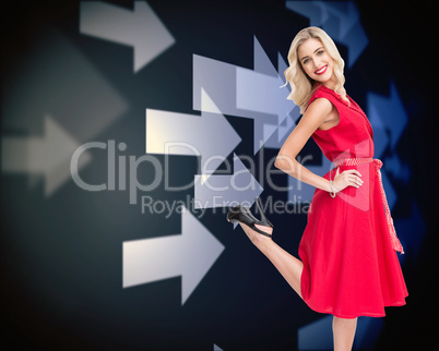 Composite image of smiling blonde standing hands on hips