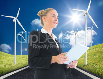 Composite image of businesswoman holding tablet