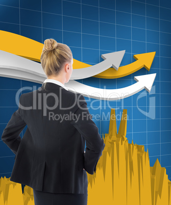 Composite image of businesswoman standing with hands on hips