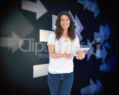 Composite image of smiling casual brunette using her tablet pc