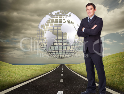 Composite image of young businessman standing cross-armed