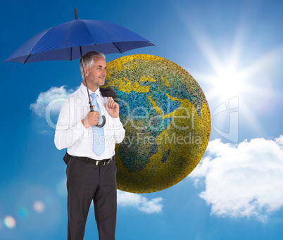 Composite image of happy businessman holding umbrella