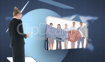 Composite image of businesswoman holding new tablet